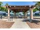 Community pavilion with picnic tables and shady pergola, perfect for outdoor gatherings at 20670 N Confetti Ct, Maricopa, AZ 85138