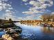 Scenic community pond with waterfall feature providing tranquil views at 20670 N Confetti Ct, Maricopa, AZ 85138