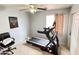 Spare bedroom featuring a ceiling fan and a Bowflex treadmill for exercise at 2072 N Wildflower Ln, Casa Grande, AZ 85122