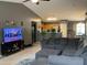 Open concept living room with sectional sofa, tile floors, and a view into the kitchen at 2072 N Wildflower Ln, Casa Grande, AZ 85122