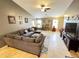 Bright living room featuring a large sectional sofa and tiled flooring with a view of the backyard at 2072 N Wildflower Ln, Casa Grande, AZ 85122