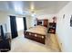 Well lit main bedroom with an ornate bed frame and matching cabinetry at 2072 N Wildflower Ln, Casa Grande, AZ 85122