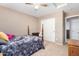 Cozy bedroom featuring a four poster bed and neutral walls at 20784 N Marina Ave, Maricopa, AZ 85139