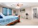 Bedroom featuring a ceiling fan, mounted TV and a view to the outside at 20784 N Marina Ave, Maricopa, AZ 85139