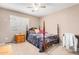 Cozy bedroom featuring a four post bed with a grey comforter and a ceiling fan at 20784 N Marina Ave, Maricopa, AZ 85139