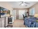 Spacious bedroom with carpeted floors, a television, and a double door closet, perfect for organization at 20784 N Marina Ave, Maricopa, AZ 85139