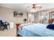 Bright bedroom featuring a ceiling fan and a TV mounted on the wall at 20784 N Marina Ave, Maricopa, AZ 85139