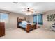 Main bedroom with natural lighting, ceiling fan, and carpet flooring at 20784 N Marina Ave, Maricopa, AZ 85139