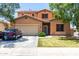 Charming two-story home features a well-maintained front lawn and a two-car garage at 20784 N Marina Ave, Maricopa, AZ 85139