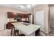 Kitchen with stainless steel appliances, tile backsplash, and a spacious kitchen island with a sink at 20784 N Marina Ave, Maricopa, AZ 85139