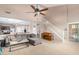 Bright living room features a vaulted ceiling, large windows, and comfortable seating at 20784 N Marina Ave, Maricopa, AZ 85139