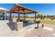 Outdoor picnic area features covered seating and a grill in a well-maintained community park at 20784 N Marina Ave, Maricopa, AZ 85139