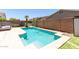 Beautiful pool with easy access steps, stone surround, and lounge seating for backyard relaxation at 20784 N Marina Ave, Maricopa, AZ 85139