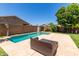 Backyard pool with lounge seating, surrounded by lush greenery, perfect for outdoor relaxation and fun at 20784 N Marina Ave, Maricopa, AZ 85139