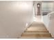 Staircase to second level with carpeted stairs, white railing, and neutral colored walls at 20784 N Marina Ave, Maricopa, AZ 85139