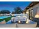 Elegant outdoor space with a pool, manicured lawn, fireplace and cozy seating area at 22619 N La Senda Dr, Scottsdale, AZ 85255