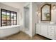 Bright bathroom featuring a soaking tub, walk-in shower, and marble vanity at 22619 N La Senda Dr, Scottsdale, AZ 85255