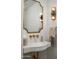 Chic bathroom with a custom concrete sink, decorative lighting, and gold fixtures at 22619 N La Senda Dr, Scottsdale, AZ 85255