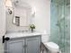 Updated bathroom featuring a glass shower, a marble vanity top, and modern fixtures at 22619 N La Senda Dr, Scottsdale, AZ 85255