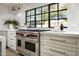 Gourmet kitchen featuring a high-end range, custom cabinetry, and a bright window view at 22619 N La Senda Dr, Scottsdale, AZ 85255