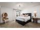 Stylish main bedroom featuring a leather bed frame, herringbone floors, and a crystal chandelier at 22619 N La Senda Dr, Scottsdale, AZ 85255