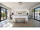 Bright main bedroom with herringbone floors, chandelier, and large picture windows at 22619 N La Senda Dr, Scottsdale, AZ 85255