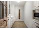 Walk-in pantry featuring custom cabinetry and herringbone wood flooring at 22619 N La Senda Dr, Scottsdale, AZ 85255