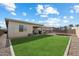 Lush backyard featuring green lawn, a covered patio, and plenty of room for recreation and relaxation at 22924 E Desert Spoon Dr, Queen Creek, AZ 85142