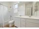 Bright bathroom featuring dual sinks, a large mirror, and a shower-tub combination with white finishes at 22924 E Desert Spoon Dr, Queen Creek, AZ 85142