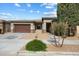 Inviting single-story home featuring a well-manicured yard, two-car garage, and neutral color scheme at 22924 E Desert Spoon Dr, Queen Creek, AZ 85142