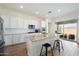 Bright kitchen with a granite island, stainless steel appliances, sleek white cabinets, and pendant lighting at 22924 E Desert Spoon Dr, Queen Creek, AZ 85142