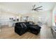 Open-concept living room showcasing tile floors and integrated kitchen with white cabinets and stainless appliances at 22924 E Desert Spoon Dr, Queen Creek, AZ 85142