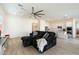 Bright living room with tile floors and integrated kitchen featuring stainless appliances and white cabinetry at 22924 E Desert Spoon Dr, Queen Creek, AZ 85142