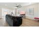 Open-concept living room with tile floors, neutral paint, and ample light with a view to dining area at 22924 E Desert Spoon Dr, Queen Creek, AZ 85142