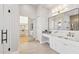 Bright bathroom featuring a marble countertop, vanity, and walk-in closet at 253 W Malibu Dr, Chandler, AZ 85248