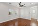 Bright bedroom with wood floors, ceiling fan, and plantation shutters at 253 W Malibu Dr, Chandler, AZ 85248