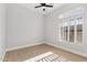 Bright bedroom featuring wood floors, a ceiling fan, and shuttered windows at 253 W Malibu Dr, Chandler, AZ 85248