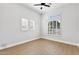 Bright bedroom featuring wood floors, a ceiling fan, and shuttered windows at 253 W Malibu Dr, Chandler, AZ 85248