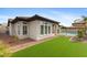 Exterior view of a well-maintained home with a manicured lawn and access to the pool area; light and bright at 253 W Malibu Dr, Chandler, AZ 85248