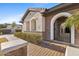 Charming front entrance with brick accents, arched gate and manicured landscaping at 253 W Malibu Dr, Chandler, AZ 85248