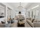 Bright, open living room featuring a modern chandelier and view into the kitchen at 253 W Malibu Dr, Chandler, AZ 85248