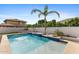 Backyard pool featuring a waterfall, tanning deck, and tropical landscaping at 253 W Malibu Dr, Chandler, AZ 85248