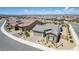 Aerial view of a house with mature desert landscaping, tile roof, and a two car garage at 27366 W Escuda Dr, Buckeye, AZ 85396