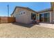 Home backyard features gravel landscaping, a paved patio, and exterior of the home at 27366 W Escuda Dr, Buckeye, AZ 85396