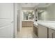 Bright bathroom featuring dual sinks, large mirrors, and a walk-in shower at 27366 W Escuda Dr, Buckeye, AZ 85396