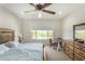 Comfortable bedroom with a natural wood bed frame and a view of desert foliage at 27366 W Escuda Dr, Buckeye, AZ 85396