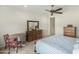 Comfortable bedroom with wooden dresser set, table and two chairs at 27366 W Escuda Dr, Buckeye, AZ 85396