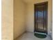 Entryway featuring textured walls, concrete floor, and a solid, dark wood front door at 27366 W Escuda Dr, Buckeye, AZ 85396