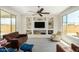 Comfortable living room featuring a ceiling fan, recessed lighting, and built-in shelving at 27366 W Escuda Dr, Buckeye, AZ 85396