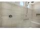 Luxurious shower with stylish tile work, convenient grab bars, and a built-in seat at 27366 W Escuda Dr, Buckeye, AZ 85396